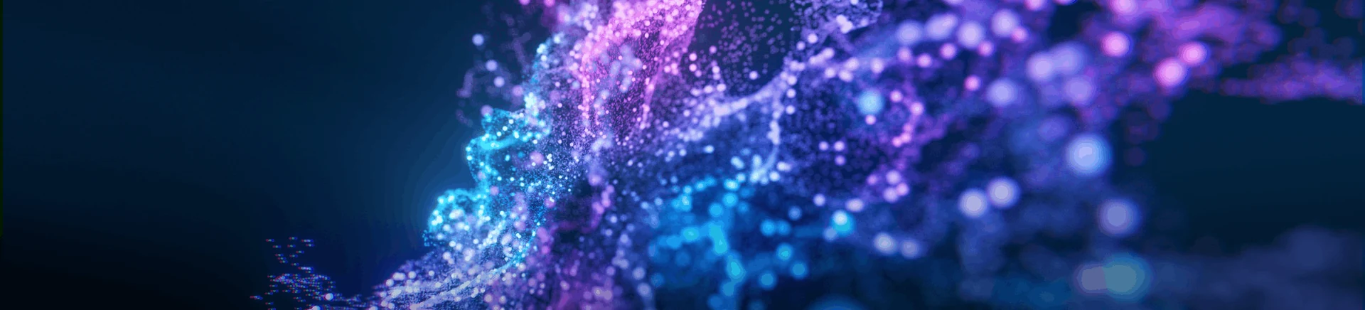 A cyan and purple particle crest against a deep blue background