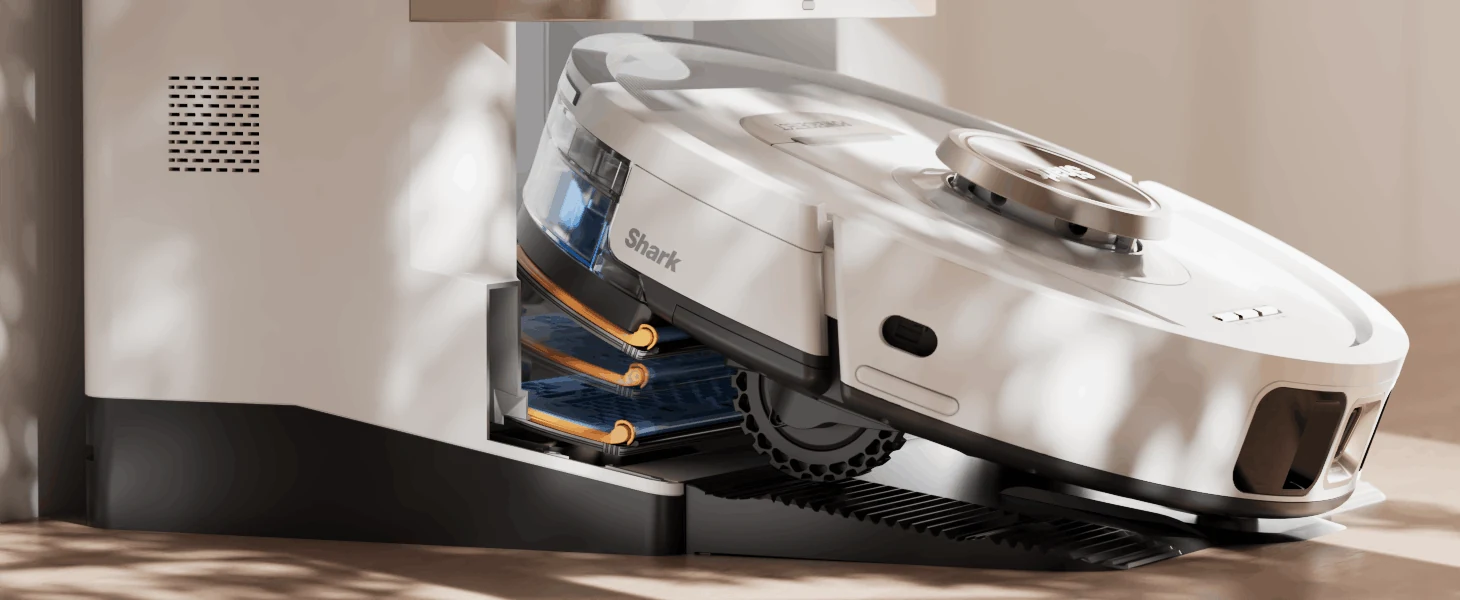 A Shark robot vacuum shown in cutaway against a softly lit home interior